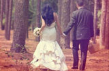 Newly married couple going beginning a journey into the woods, hand in hand